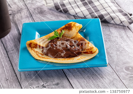 Sweet pancake with chocolate paste 138750977