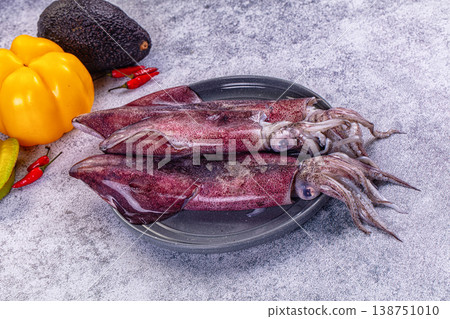 Fresh raw squid on a plate with exotic vegetables for cooking Fresh raw squid on a plate with exotic vegetables for cooking 138751010