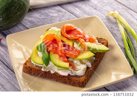 Smoked Salmon and Avocado Toast with Cream Cheese on Rustic Wood Table 138751032