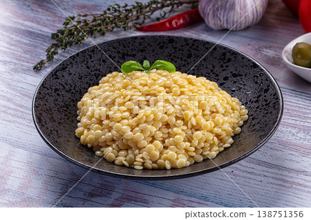 Boiled ptitim pasta served basil Boiled ptitim pasta served basil 138751356