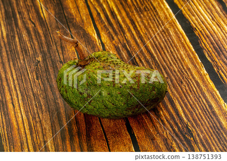 One whole raw soursop fruit, or graviola, isolated on a textured background. 138751393
