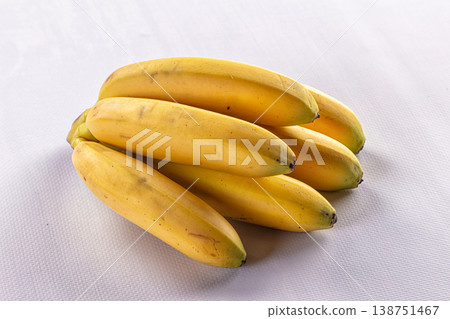 Fresh bunch of ripe yellow bananas isolated on a white background Fresh bunch of ripe yellow bananas isolated on a white background 138751467