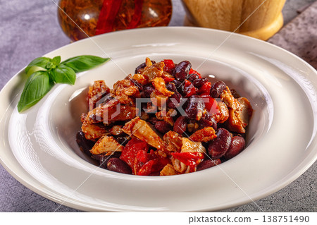 Chicken and red bean stew with peppers and basil in a white bowl Chicken and red bean stew with peppers and basil in a white bowl 138751490