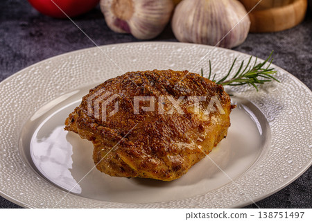 Roasted chicken thigh with crispy skin and rosemary on a white plate Roasted chicken thigh with crispy skin and rosemary on a white plate 138751497