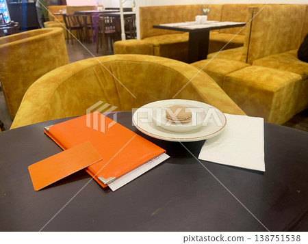 a table with a plate and a napkin on it a table with a plate and a napkin on it 138751538