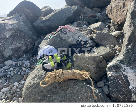 mountaineering equipment lies on a rock on a clear day mountaineering equipment lies on a rock on a clear day 138751586
