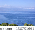 Picturesque view to blue sea and mountain island on horizon in mist. Calm water surface, background for traveling and vacation,Beautiful sea view, sailboats far away in the sea in sunny day. 138751691