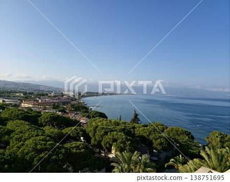 Picturesque view of turkey coast, Kusadasi, Audin, blue sea and mountain on horizon in mist. Calm water surface, background for traveling and vacation, Beautiful sea view, sea in sunny day. Picturesque view of turkey coast, Kusadasi, Audin, blue sea and mountain on horizon in mist. Calm water surface, background for traveling and vacation, Beautiful sea view, sea in sunny day. 138751695