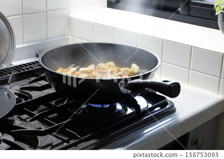 Cooking in a deep frying pan 138753093