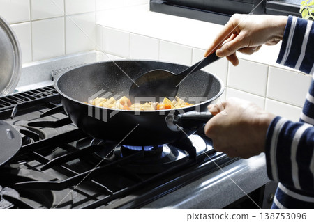 Cooking in a deep frying pan 138753096