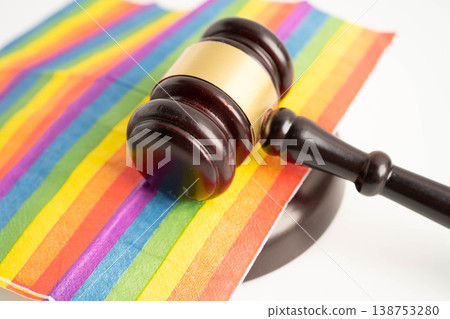 Gavel for judge lawyer on rainbow flag, symbol of LGBT pride month. Gavel for judge lawyer on rainbow flag, symbol of LGBT pride month. 138753280