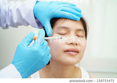Asian woman receiving filler beauty injection. Asian woman receiving filler beauty injection. 138753473