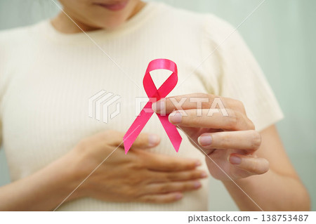 Asian woman with pink ribbon for October world breast cancer day. Asian woman with pink ribbon for October world breast cancer day. 138753487