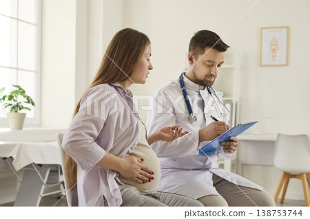 Prenatal consultation with doctor and pregnant woman in clinic, healthcare visit 138753744