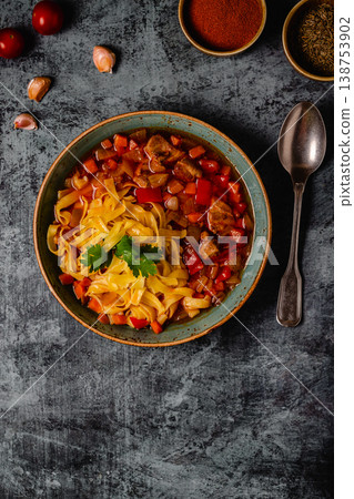 Lagman soup with lamb, homemade noodles and vegetables. 138753902