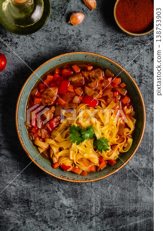 Lagman soup with lamb, homemade noodles and vegetables. 138753903