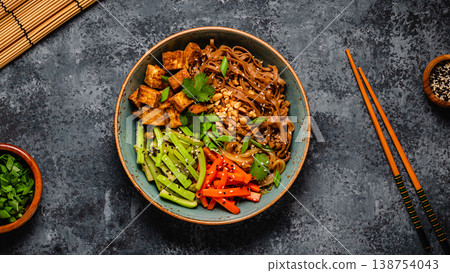 Soba noodles with vegetables and fried tofu in a bowl. Soba noodles with vegetables and fried tofu in a bowl. 138754043