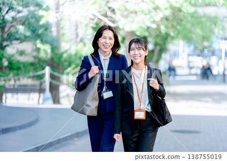 Two businesswomen walking together 138755019