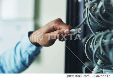 Person, hands and technician with network cable in mainframe for internet connection or maintenance. Closeup, IT engineer or troubleshooting technology for hardware repair or fix in server room Person, hands and technician with network cable in mainframe for internet connection or maintenance. Closeup, IT engineer or troubleshooting technology for hardware repair or fix in server room 138755516