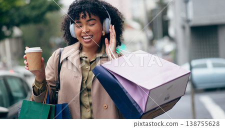 Headphones, shopping bag or happy woman in city for boutique retail sale, or clothes discount deal. Coffee, financial freedom or rich customer walking on street streaming radio music with fashion 138755628
