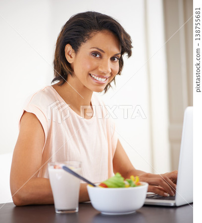 Remote work, laptop and woman eating a salad, healthy food or nutrition in home and office. Happy, portrait and working on lunch break with fruit and vegetables for energy, wellness and diet 138755681