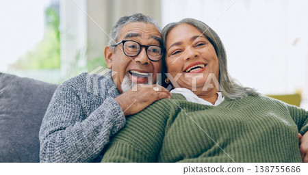 Watching tv, home and senior couple on a couch, love and relax with a smile, retirement and marriage. Romance, old man and elderly woman on a sofa, movies and films with relationship and laughing 138755686