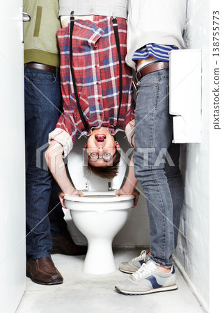 Geek, bully and students in a school toilet for abuse, fear or hazing of a victim in a bathroom stall. Portrait, dunk and upside down with a teen nerd embarrassed by thugs at university or college Geek, bully and students in a school toilet for abuse, fear or hazing of a victim in a bathroom stall. Portrait, dunk and upside down with a teen nerd embarrassed by thugs at university or college 138755773
