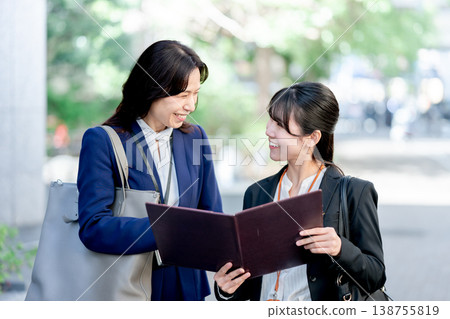 Businesswomen having a conversation outdoors Businesswomen having a conversation outdoors 138755819