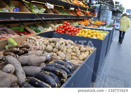 A scene from a European greengrocer's with various vegetables on display. A scene from a European greengrocer's with various vegetables on display. 138755924