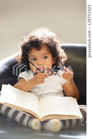 Toddler, glasses or book read fun education, learning or childhood development knowledge. Little girl, sofa or story telling dress up professional or school work for funny, comedy or academic joke Toddler, glasses or book read fun education, learning or childhood development knowledge. Little girl, sofa or story telling dress up professional or school work for funny, comedy or academic joke 138755925