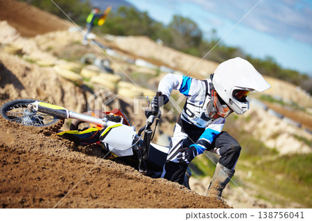 Accident, fitness and man biker on a dirt road for competition, race or training workout. Sports, motorcycle and frustrated male athlete with mistake on bike in outdoor sand dunes or desert for hobby 138756041
