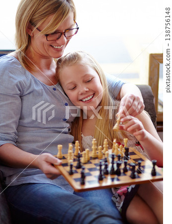 Happy, chess and a mother and child with a game for competition, strategy or thinking. Smile, family and a mom, girl or kid on a home sofa with a board for gaming, education and learning a hobby 138756148