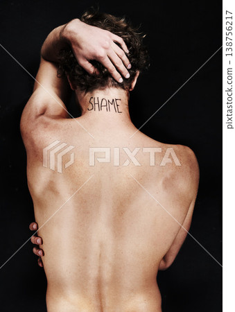 Back, shame tattoo and nude man in studio isolated on a black background. Rear view, regret and body of person embarrassed at mistake, fail and abuse crisis, depression and mental health challenge Back, shame tattoo and nude man in studio isolated on a black background. Rear view, regret and body of person embarrassed at mistake, fail and abuse crisis, depression and mental health challenge 138756217