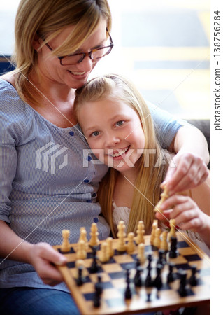 Portrait, happy and a mother and child with chess for education, strategy and teaching a game. Smile, family and a girl, kid and a mom with a board for learning a hobby, playing and bonding at home Portrait, happy and a mother and child with chess for education, strategy and teaching a game. Smile, family and a girl, kid and a mom with a board for learning a hobby, playing and bonding at home 138756284