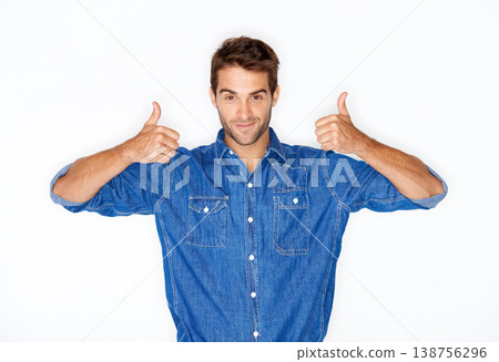 Portrait, fashion and thumbs up with a man in studio isolated on a white background for success or support. Hands, emoji for thank you and a young model indoor to gesture as a winner with motivation 138756296