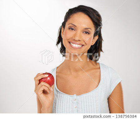 Happy woman, portrait and apple for natural nutrition, health diet or snack against a studio background. Face of female person or model smile with red organic fruit for fiber, vitamin or healthy meal Happy woman, portrait and apple for natural nutrition, health diet or snack against a studio background. Face of female person or model smile with red organic fruit for fiber, vitamin or healthy meal 138756384