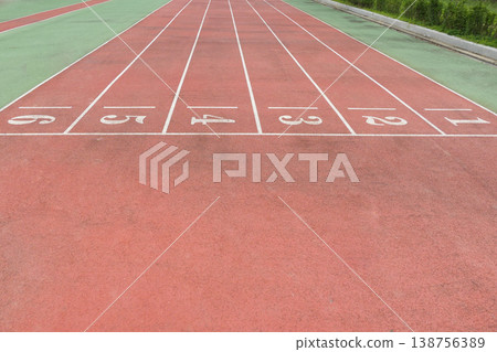 a Red Running Track with White Lane Markings 138756389