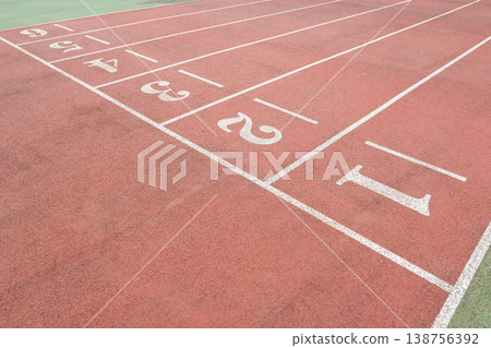 a Red Running Track with White Lane Markings 138756392