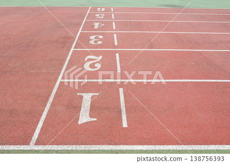 a Red Running Track with White Lane Markings 138756393