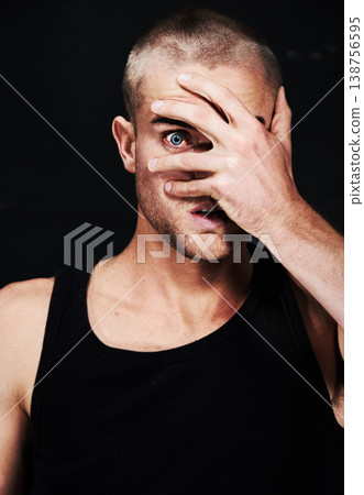 Portrait, anxiety and man peek through hands in studio isolated on a black background. Face, scared and person peep through fingers, spy or paranoid at horror, fear danger or stress for mental health Portrait, anxiety and man peek through hands in studio isolated on a black background. Face, scared and person peep through fingers, spy or paranoid at horror, fear danger or stress for mental health 138756595