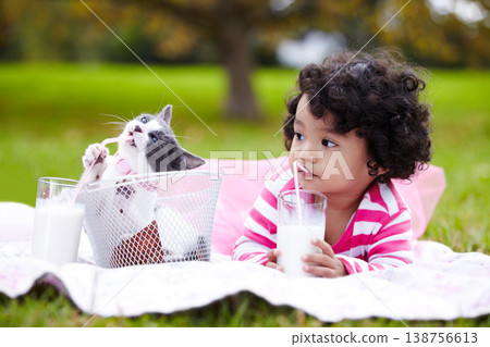 Milk, picnic and a girl in the park with her kitten together for love, care or bonding during summer. Summer, straw or kids and happy young child in the garden drinking from a glass with her pet cat Milk, picnic and a girl in the park with her kitten together for love, care or bonding during summer. Summer, straw or kids and happy young child in the garden drinking from a glass with her pet cat 138756613