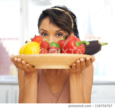 Portrait, eyes and vegetables with a woman in the kitchen of her home for nutrition, diet or meal preparation. Health, ingredients and a recipe for cooking food with a young person in her apartment Portrait, eyes and vegetables with a woman in the kitchen of her home for nutrition, diet or meal preparation. Health, ingredients and a recipe for cooking food with a young person in her apartment 138756787