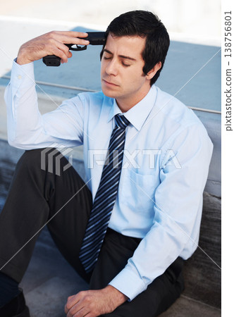 Businessman, suicide and gun with stress, depression and mental health with sadness outdoor on building. Professional, person or employee and weapon with anxiety, risk or crisis with unhappy face 138756801