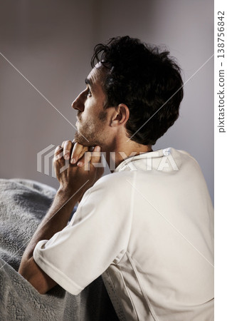 Man, praying and home for faith, religion and hope in bedroom asking for help with mental health, depression or loss. Sad Christian person in prayer thinking of job, spiritual guidance or worship God 138756842