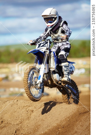 Man, motorcycle and bike hill jump as professional rider in action danger competition, fearless or race. Male person, transportation or fast speed dirt adventure or rally, challenge gear or driving Man, motorcycle and bike hill jump as professional rider in action danger competition, fearless or race. Male person, transportation or fast speed dirt adventure or rally, challenge gear or driving 138756865