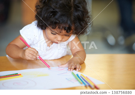 Young, girl or drawing at table in classroom for creative development, education growth in kindergarten. Child, daycare or pencils artwork for learning play in school or paper crayons, craft or color 138756880