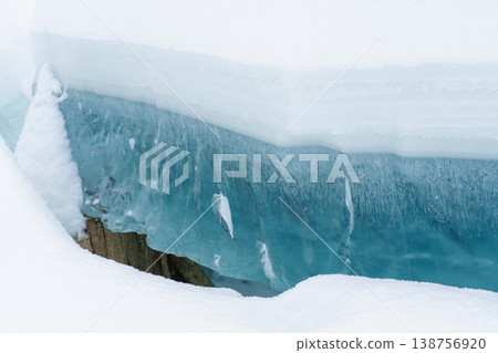 Frozen Lake Nukabira: A beautiful winter landscape with crystal-clear blue ice. Frozen Lake Nukabira: A beautiful winter landscape with crystal-clear blue ice. 138756920