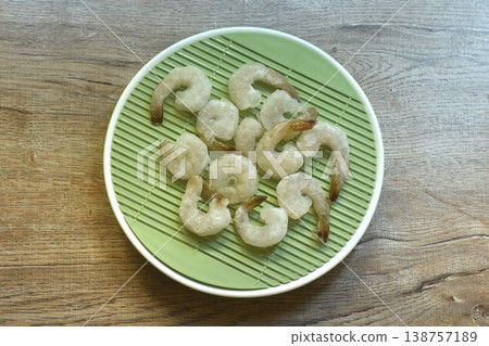 raw frozen shrimp food ingredient arranging on plate raw frozen shrimp food ingredient arranging on plate 138757189