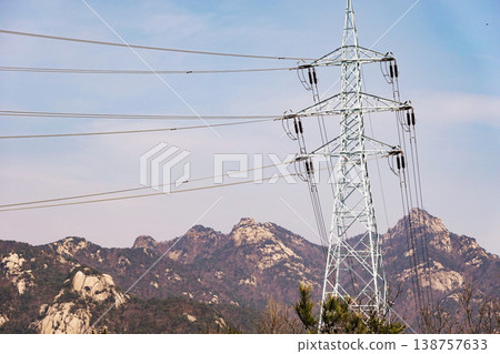 High Voltage Transmission Tower with Bukhansan Mountain Background, Korea. High Voltage Transmission Tower with Bukhansan Mountain Background, Korea. 138757633