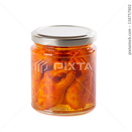 Canned crab claws in a glass jar isolated on white background. Marinated crayfish or crab pincers in oil. 138757802